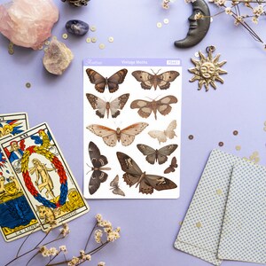 May include: A sheet of vintage moth stickers with a light brown background. The stickers feature detailed illustrations of moths in various poses. The sheet is labeled "Vintage Moths" and "PS461".