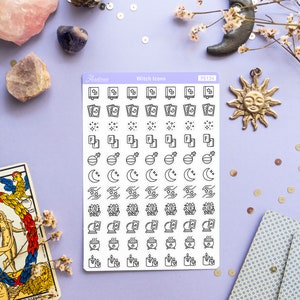 May include: A sheet of white sticker paper with black witch icons. The icons include books, stars, moons, crystals, cauldrons, and candles. The sticker sheet is labeled "Witch Icons" and "PS134".
