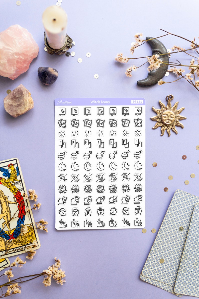 May include: A sheet of white sticker paper with black witch icons. The icons include books, stars, moons, crystals, cauldrons, and candles. The sticker sheet is labeled "Witch Icons" and "PS134".