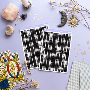 May include: Two sheets of black and white night sky washi tape with white stars and clouds. The washi tape is labeled "Night Sky Washi" and has the product number "WS018" and "WS019".