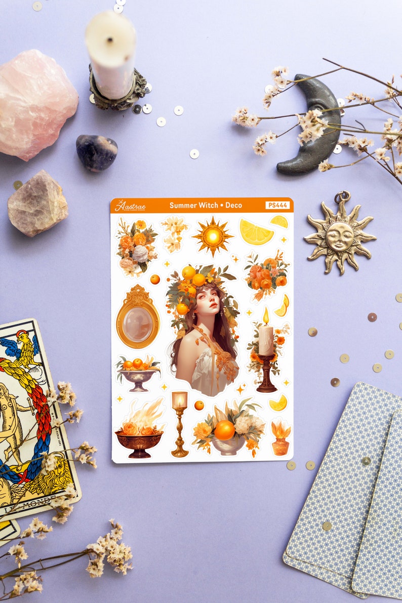 May include: A sheet of stickers featuring a summer witch theme. The stickers include a woman with a crown of oranges, a sun, a candle, a mirror, and a bowl of oranges. The stickers are on a white background with the text "Summer Witch - Deco" and "PS444" printed on the sheet.