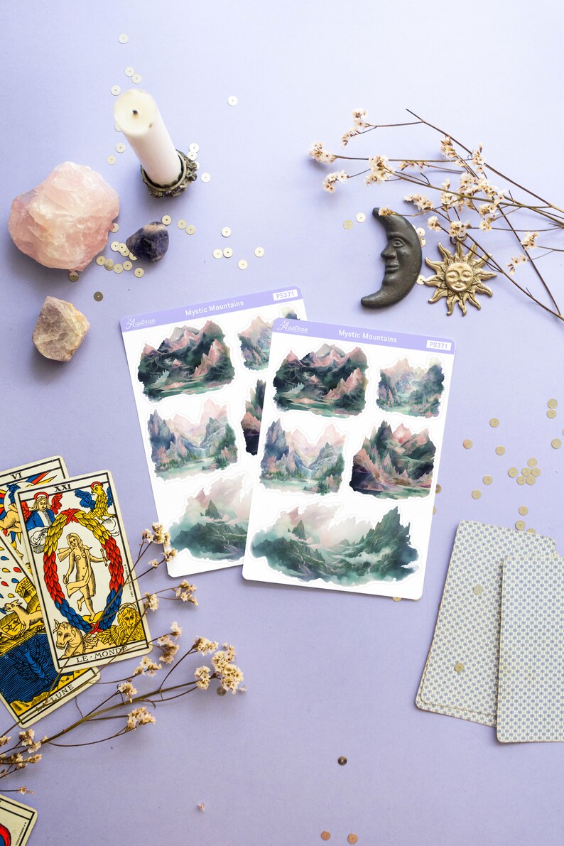 May include: Two sheets of stickers with a watercolor illustration of a mountain range with a lake in the foreground. The stickers are labeled "Mystic Mountains" and "PS371".