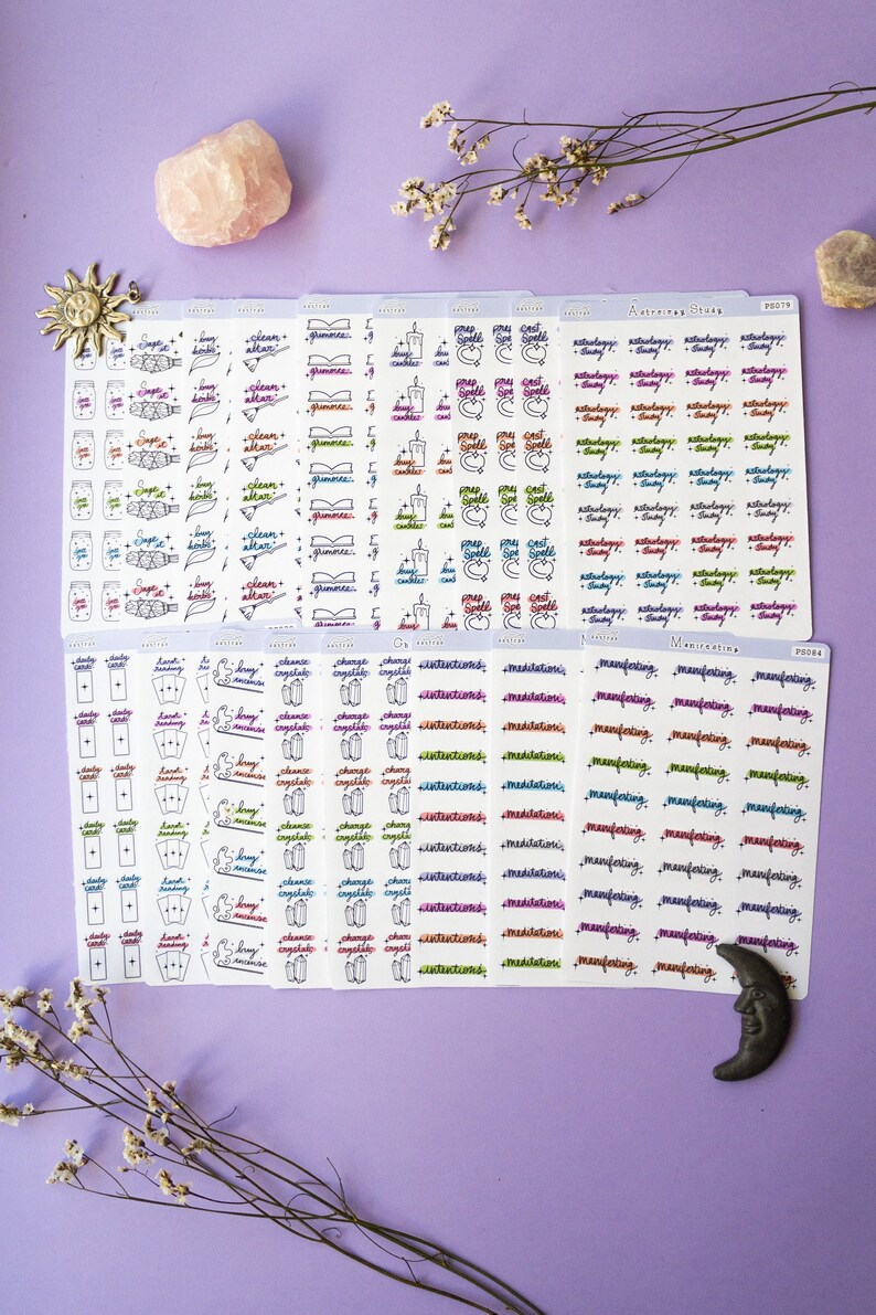 May include: A set of 10 sheets of stickers featuring various designs related to witchcraft and magic. The stickers are white with black outlines and colorful text. Some of the designs include candles, crystals, tarot cards, and the words "Intentions", "Meditations", and "Manifesting".