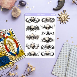 May include: A sheet of skull divider stickers with a white background and black and gray skulls with ornate designs. The sheet is labeled "Skull Dividers" and "PS311".