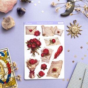 May include: A sheet of stickers featuring Victorian-style love letters, envelopes, and bouquets of red roses. The stickers are on a white background and have a vintage aesthetic. The text "Victorian Love Letters" is printed at the top of the sheet.