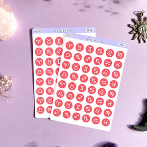 May include: Two sheets of pink sticker paper with red circle stickers featuring the astrological signs. The stickers are labeled "Zodiac Icons" and "PS121".