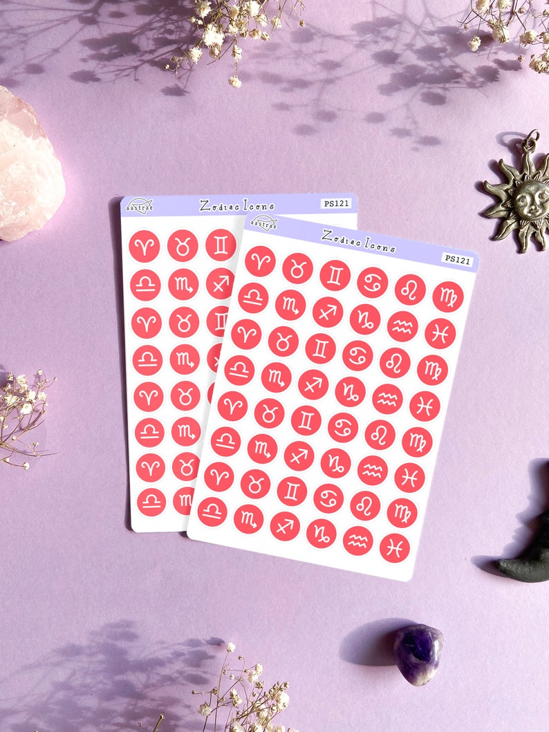 May include: Two sheets of pink sticker paper with red circle stickers featuring the astrological signs. The stickers are labeled "Zodiac Icons" and "PS121".