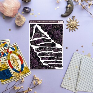 May include: A sheet of washi tape with a black and purple floral design. The tape features a repeating pattern of dark purple roses and leaves. The text "Gothic Victorian Garden - Washi" and "PS413" is printed on the sheet.