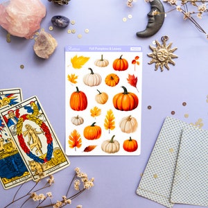 May include: A sheet of stickers featuring illustrated fall pumpkins and leaves. The stickers are on a white background and have a light blue border. The sheet is labeled "Fall Pumpkins & Leaves" and "PS283".