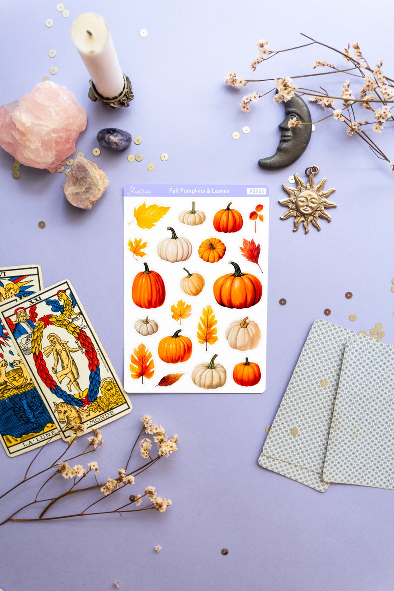 May include: A sheet of stickers featuring illustrated fall pumpkins and leaves. The stickers are on a white background and have a light blue border. The sheet is labeled "Fall Pumpkins & Leaves" and "PS283".