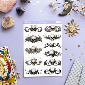 May include: A sheet of skull divider stickers with a white background. The stickers feature black and white illustrations of skulls with intricate floral designs. The sheet is labeled "Skull Dividers" and "PS311".