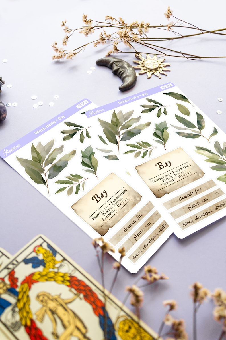 May include: A sheet of stickers featuring illustrations of bay leaves and text about the herb's properties. The text reads "Bay, Protection, Purification, Psychic Powers, Strength, Healing, Element: Fire, Planet: Sun, Deities: Aesculapius, Apollo".