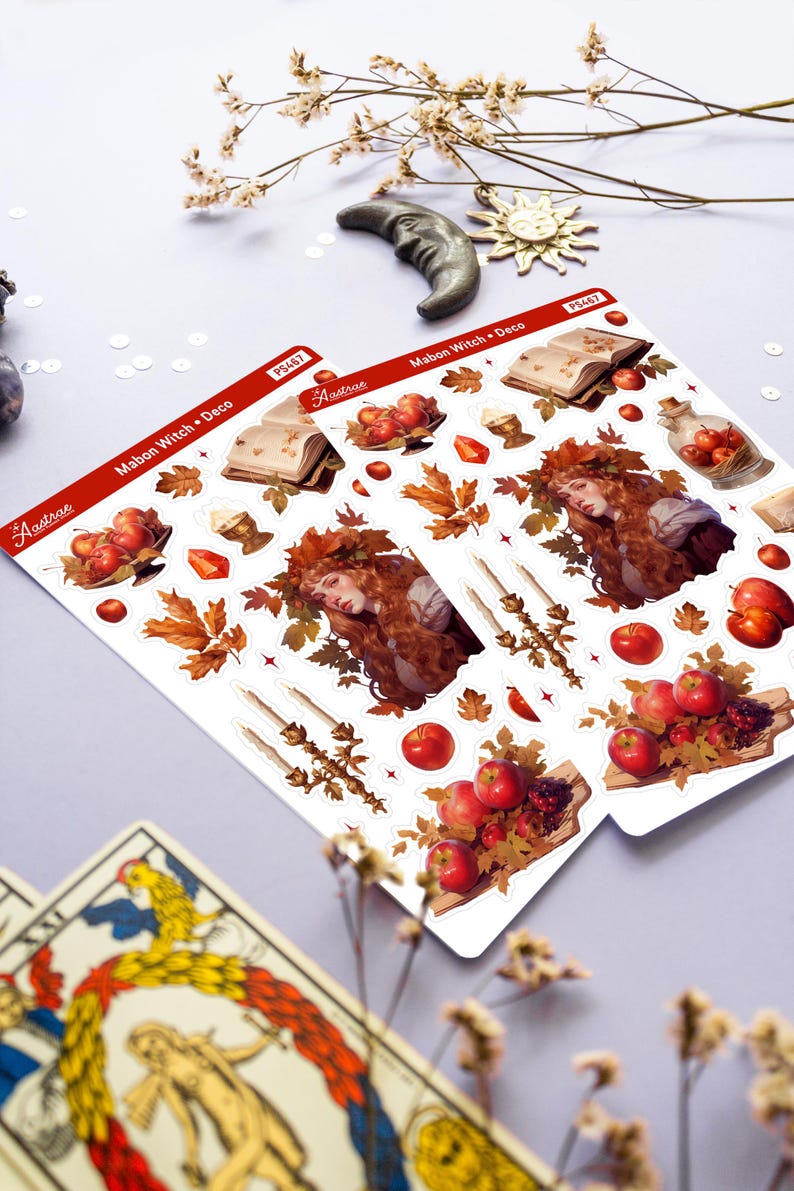 May include: Two sheets of stickers featuring a witch with red hair and a crown of leaves, apples, a book, candles, and other autumnal elements. The stickers are labeled "Mabon Witch + Deco" and "PS467".