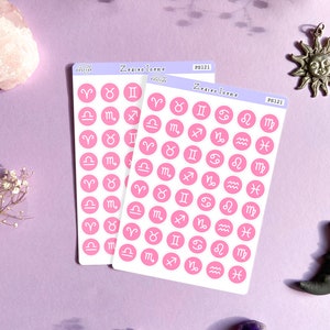 May include: Two sheets of pink stickers with white outlines of the zodiac signs. The stickers are labeled "Zodiac Icons" and "PS121".