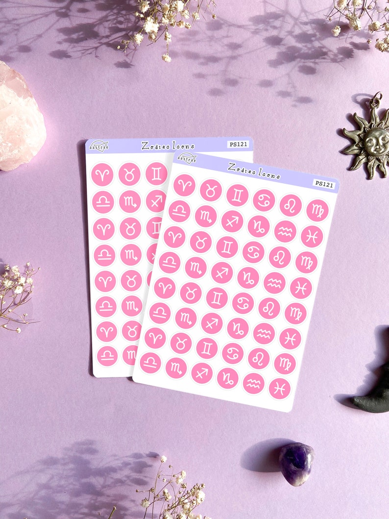 May include: Two sheets of pink stickers with white outlines of the zodiac signs. The stickers are labeled "Zodiac Icons" and "PS121".
