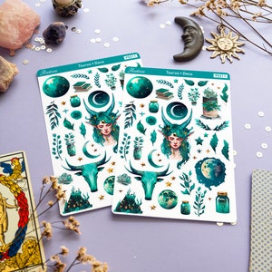 May include: Two sheets of stickers featuring a green and gold Taurus zodiac theme. The stickers include a bull, a woman with green hair, a crescent moon, stars, and plants. The sheets are labelled "Taurus + Deco" and "Hastrae" with the product number "PS211".