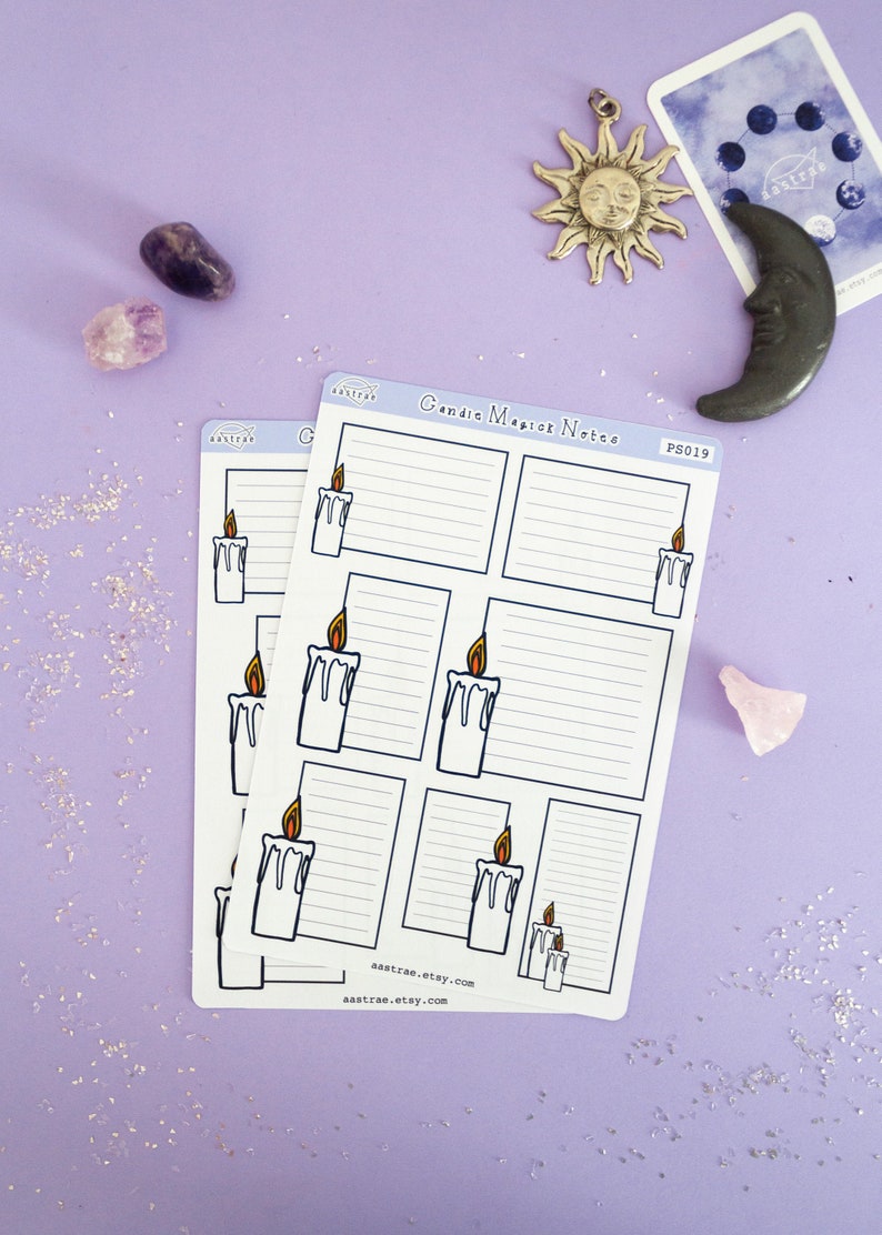 May include: Two sheets of candle magic notes with a white background and black lines. Each sheet has six sections with a candle illustration and space for writing. The text "Candle Magic Notes" and "PS019" are printed on the top of the sheet. The sheets are on a purple background with glitter.