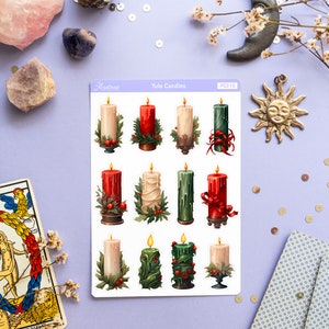 May include: A sheet of stickers featuring twelve illustrated Yule candles in various colors and designs. The candles are decorated with holly, ribbons, and other festive details. The sheet is labeled "Yule Candles" and "PS315".