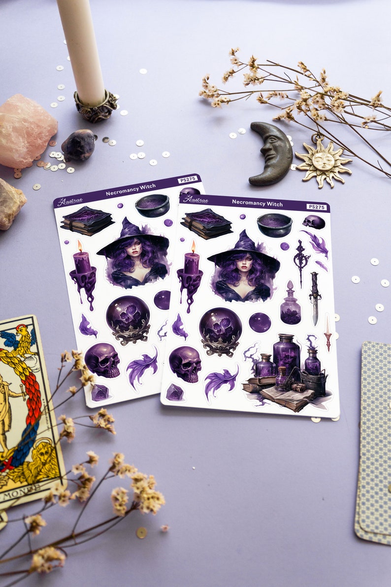 May include: Two sheets of stickers featuring a purple and black witch with a cauldron, skulls, potion bottles, and books. The stickers are labelled "Necromancy Witch" and "Astraea" with the product number "PS275".