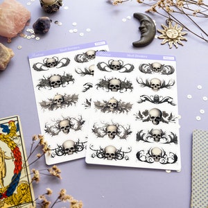 May include: Two sheets of skull divider stickers with a white background and black and gray skull designs. The stickers are labeled "Skull Dividers" and have a product number of "PS311".