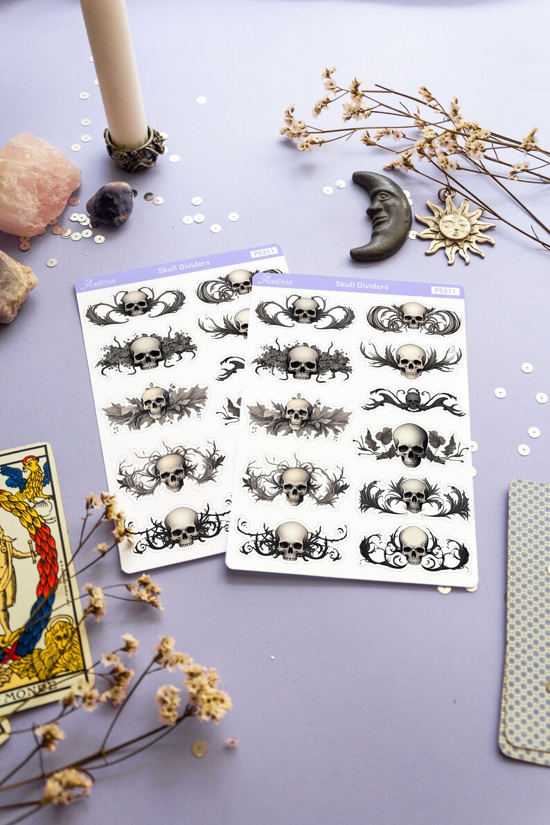 May include: Two sheets of skull divider stickers with a white background and black and gray skull designs. The stickers are labeled "Skull Dividers" and have a product number of "PS311".