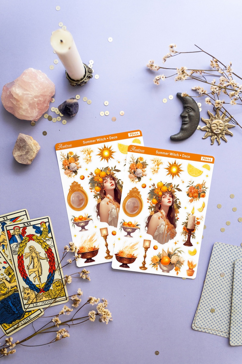 May include: Two sheets of stickers featuring a summer witch theme. The stickers are on a white background and feature illustrations of a woman with a wreath of lemons and flowers on her head, a sun, a lemon, a candle, and a bowl of oranges. The text on the stickers reads "Summer Witch Deco" and "Aastrae".