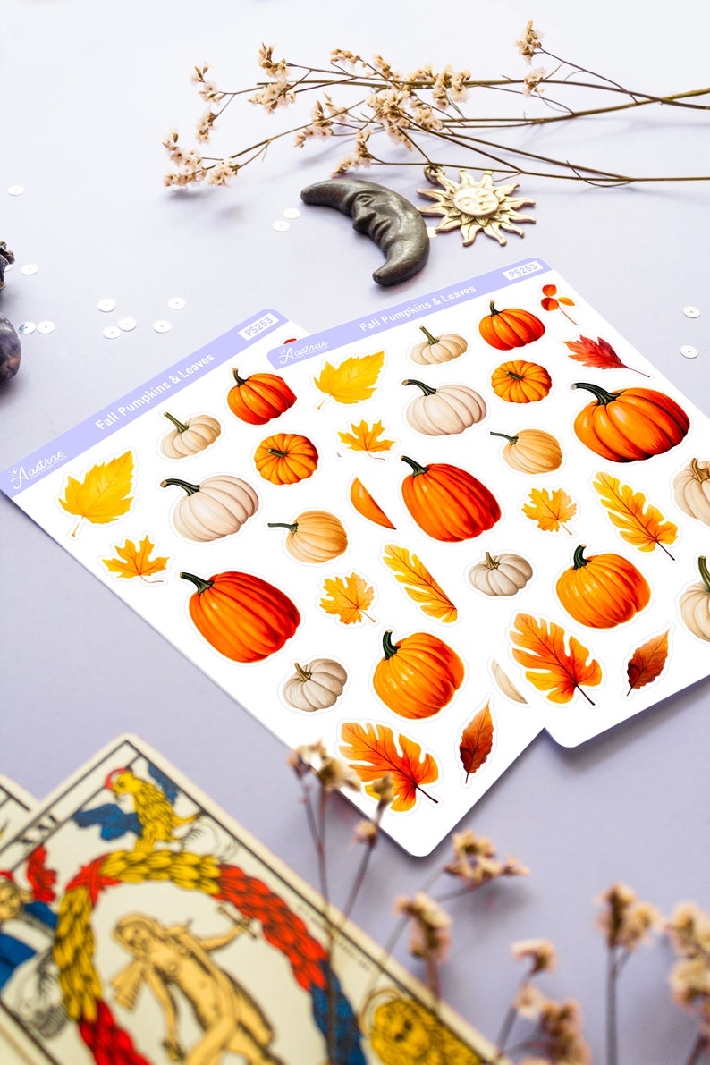 May include: Two sheets of stickers featuring fall-themed pumpkins and leaves. The stickers are white with a light purple border and the text "Fall Pumpkins & Leaves" printed on each sheet. The stickers are arranged in rows and include various sizes and colors of pumpkins and leaves.