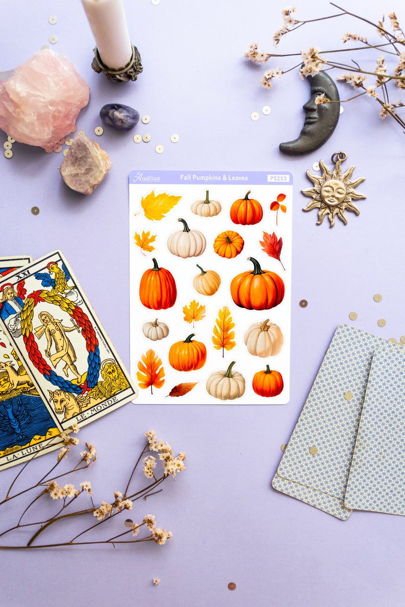May include: A sheet of stickers featuring fall-themed illustrations of pumpkins and leaves. The stickers are on a white background and have a light blue border. The text "Fall Pumpkins & Leaves" is printed on the sheet. The stickers are arranged in a grid pattern.