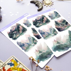 May include: A sheet of stickers featuring watercolor illustrations of misty mountains. The stickers are labeled "Mystic Mountains" and "Aestrea".