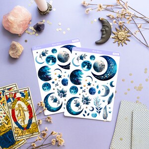 May include: Two sheets of blue moon themed stickers with gold accents. The stickers feature moons, stars, and floral designs. The sheets are labeled "Blue Moon" and "PS102".