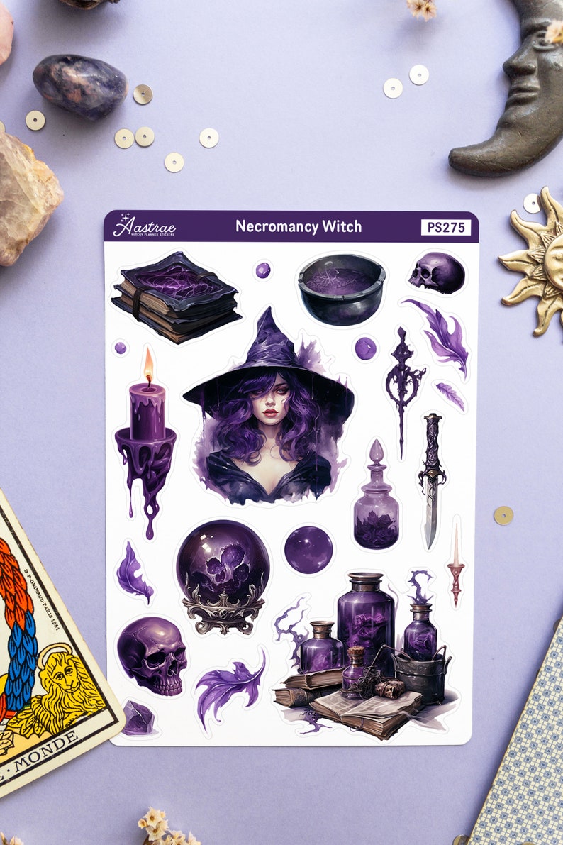 May include: A sheet of stickers featuring a purple and black necromancer witch with a cauldron, potion bottles, a crystal ball, a skull, and a book. The sticker sheet is titled "Necromancy Witch" and has the product code "PS275".