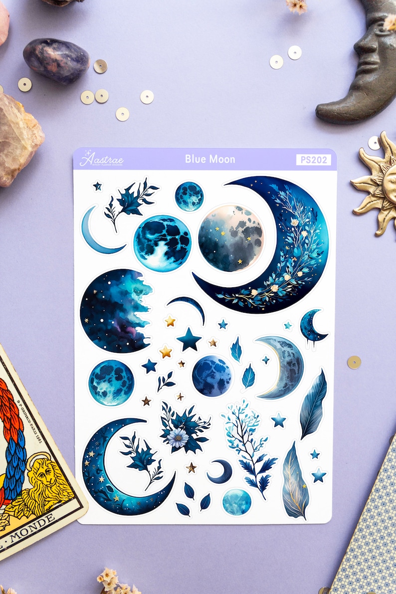 May include: A sheet of blue moon themed stickers with crescent moons, full moons, and stars. The stickers are on a white background with the text "Blue Moon" and "PS202" printed on the sheet.