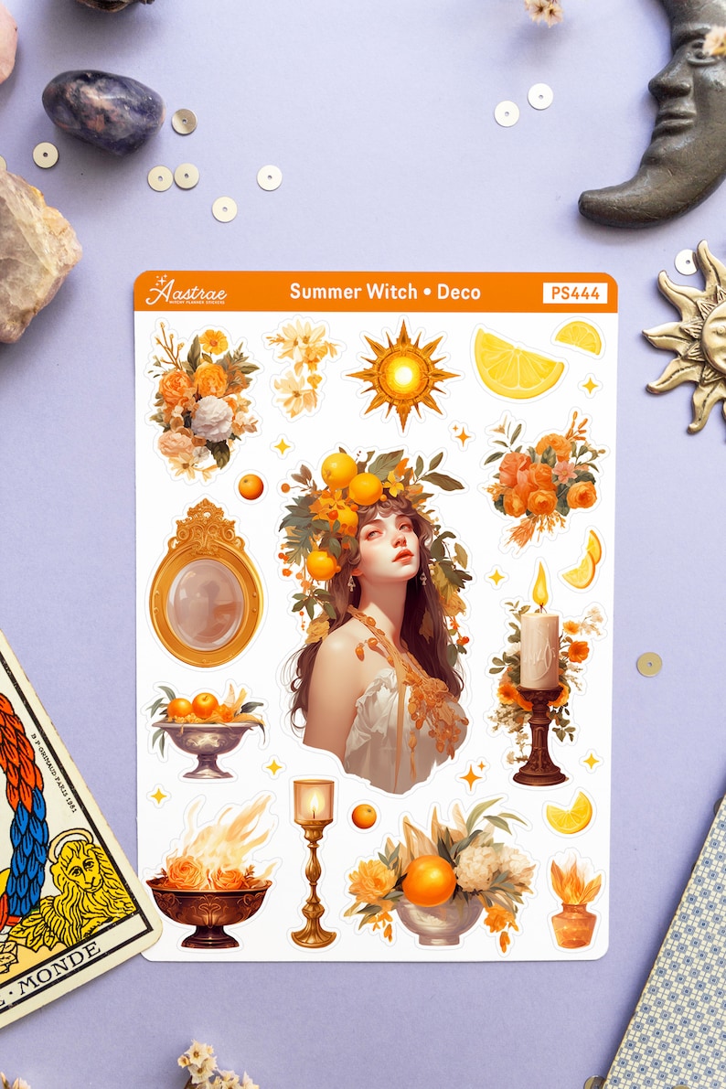 May include: A sheet of stickers featuring a summer witch theme. The stickers include a woman with a crown of oranges, a sun, a lemon, a candle, a bowl of oranges, and a fire bowl. The stickers are on a white background with the text "Summer Witch &bull; Deco" and "PS444".