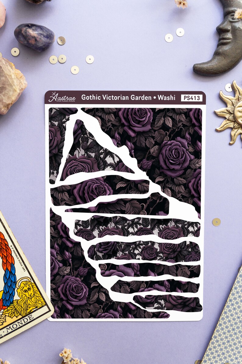 May include: A sheet of washi tape with a gothic Victorian garden design. The tape features a dark background with purple roses and leaves. The tape is cut into different shapes, including a large triangle and several rectangles. The text "Gothic Victorian Garden - Washi" and "PS413" is printed on the tape.