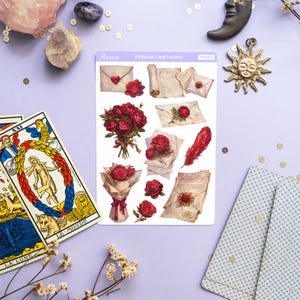 May include: A sheet of stickers featuring Victorian-style illustrations of roses, envelopes, and handwritten letters. The stickers are on a white background with a purple border and the text "Victorian Love Letters" in black.