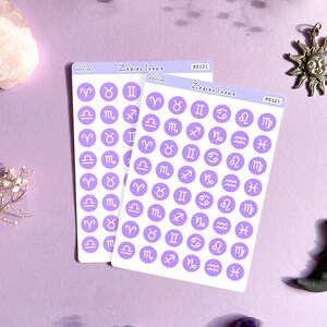 May include: Two sheets of purple sticker paper with white circle stickers featuring the zodiac signs. The stickers are labeled "Zodiac Icons" and "PS121".