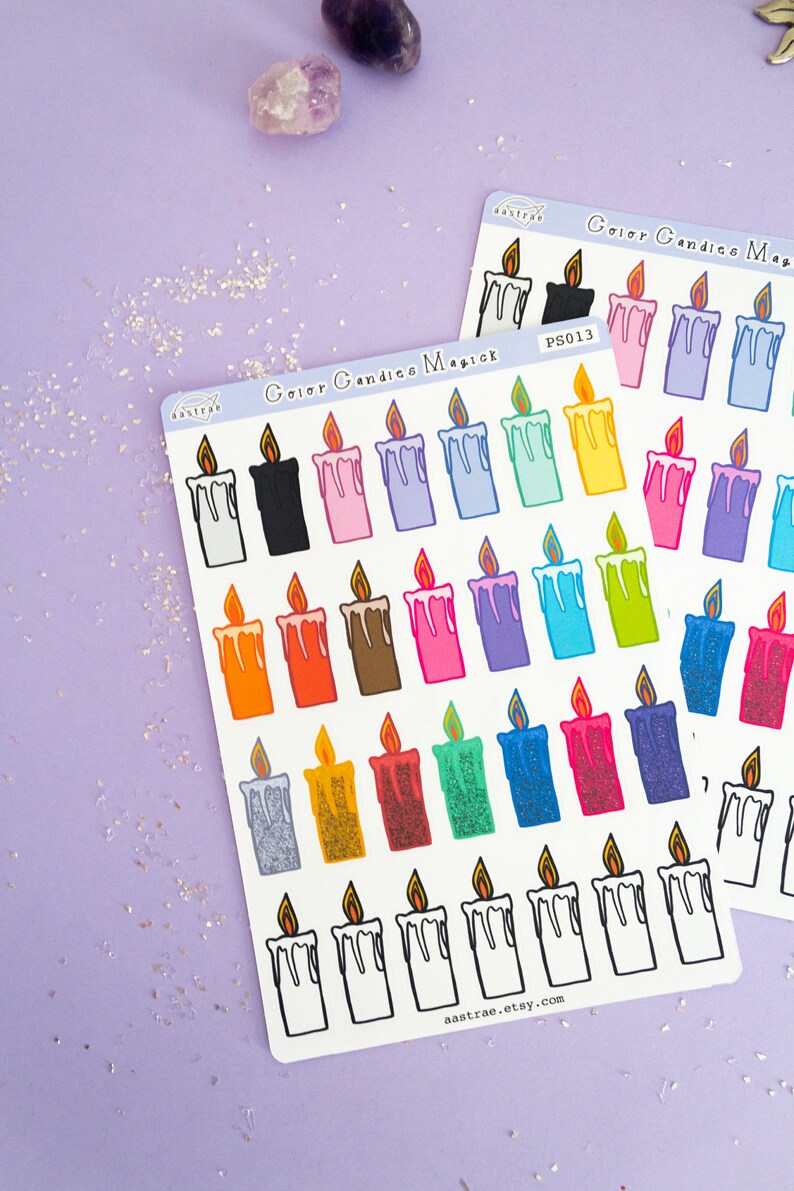 May include: A sheet of colorful candle stickers with the text "Color Candles Magick" and "aastrae.etsy.com". The stickers feature various colors of candles with dripping wax and flames.