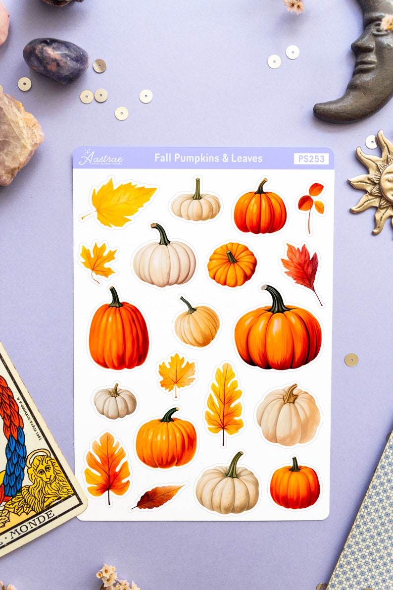 May include: A sheet of stickers featuring fall-themed pumpkins and leaves. The stickers are white with a variety of orange, white, and brown pumpkins and leaves. The sheet is labeled "Fall Pumpkins & Leaves" and "PS253".