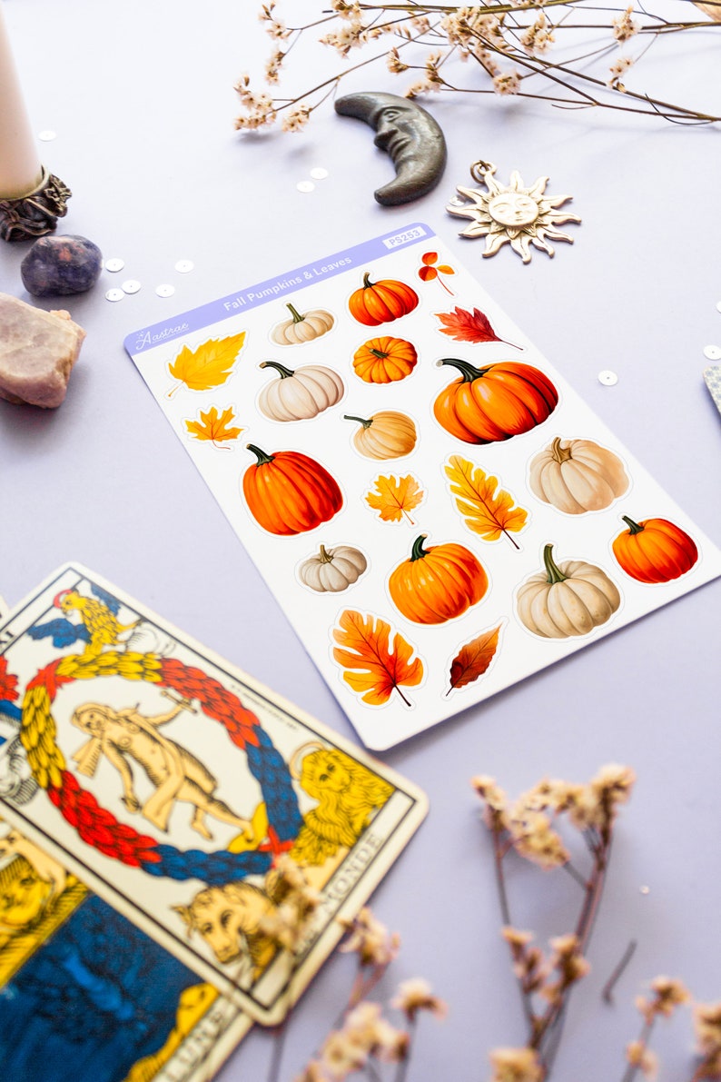 May include: A sheet of stickers featuring fall-themed pumpkins and leaves. The stickers are white with a light blue border and the text "Fall Pumpkins & Leaves" in black. The stickers are arranged in rows and include various sizes and colors of pumpkins and leaves.