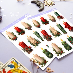 May include: Two sheets of stickers featuring illustrations of Yule candles. The candles are red, green, and white with holly and berries. The stickers are labeled "Yule Candles" and "Arcturus".