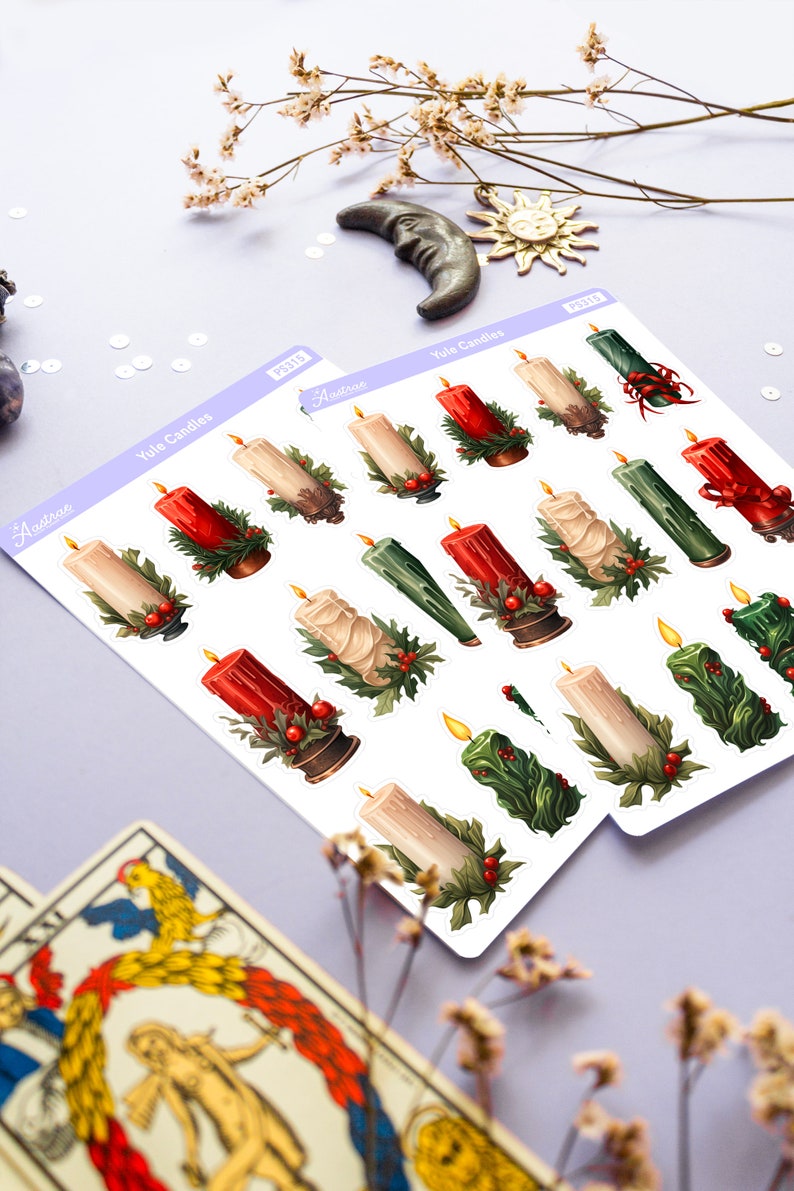 May include: Two sheets of stickers featuring illustrations of Yule candles. The candles are red, green, and white with holly and berries. The stickers are labeled "Yule Candles" and "Arcturus".