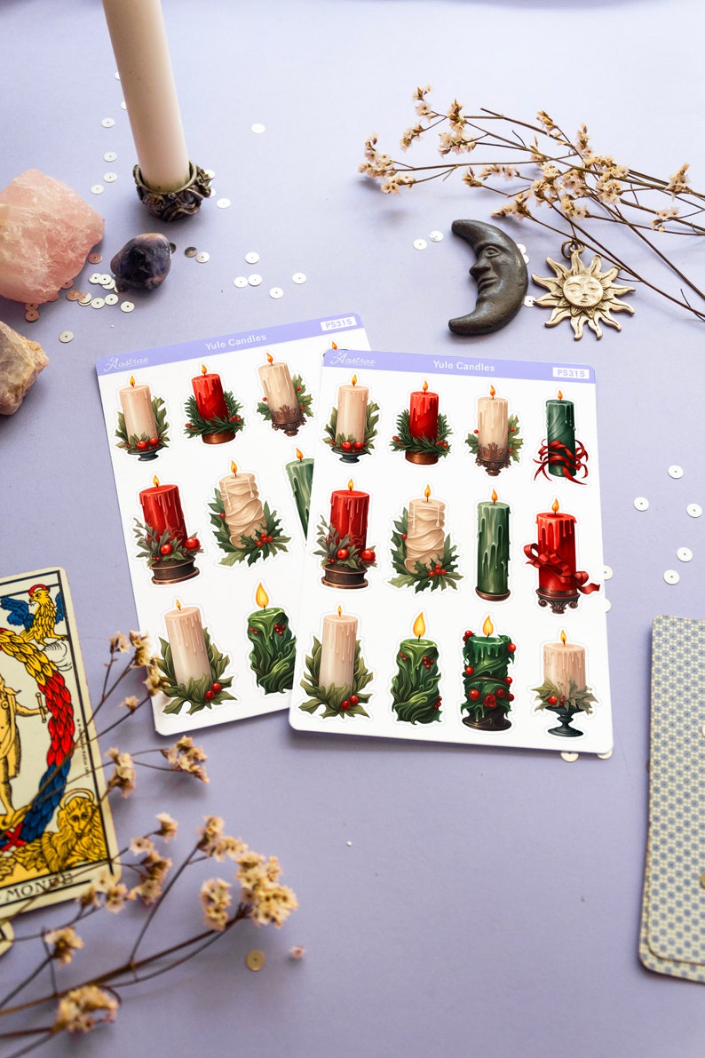 May include: Two sheets of stickers featuring Yule candles. The stickers are white with a purple border and the text "Yule Candles" printed in black. The stickers feature illustrations of candles decorated with holly and red ribbon.