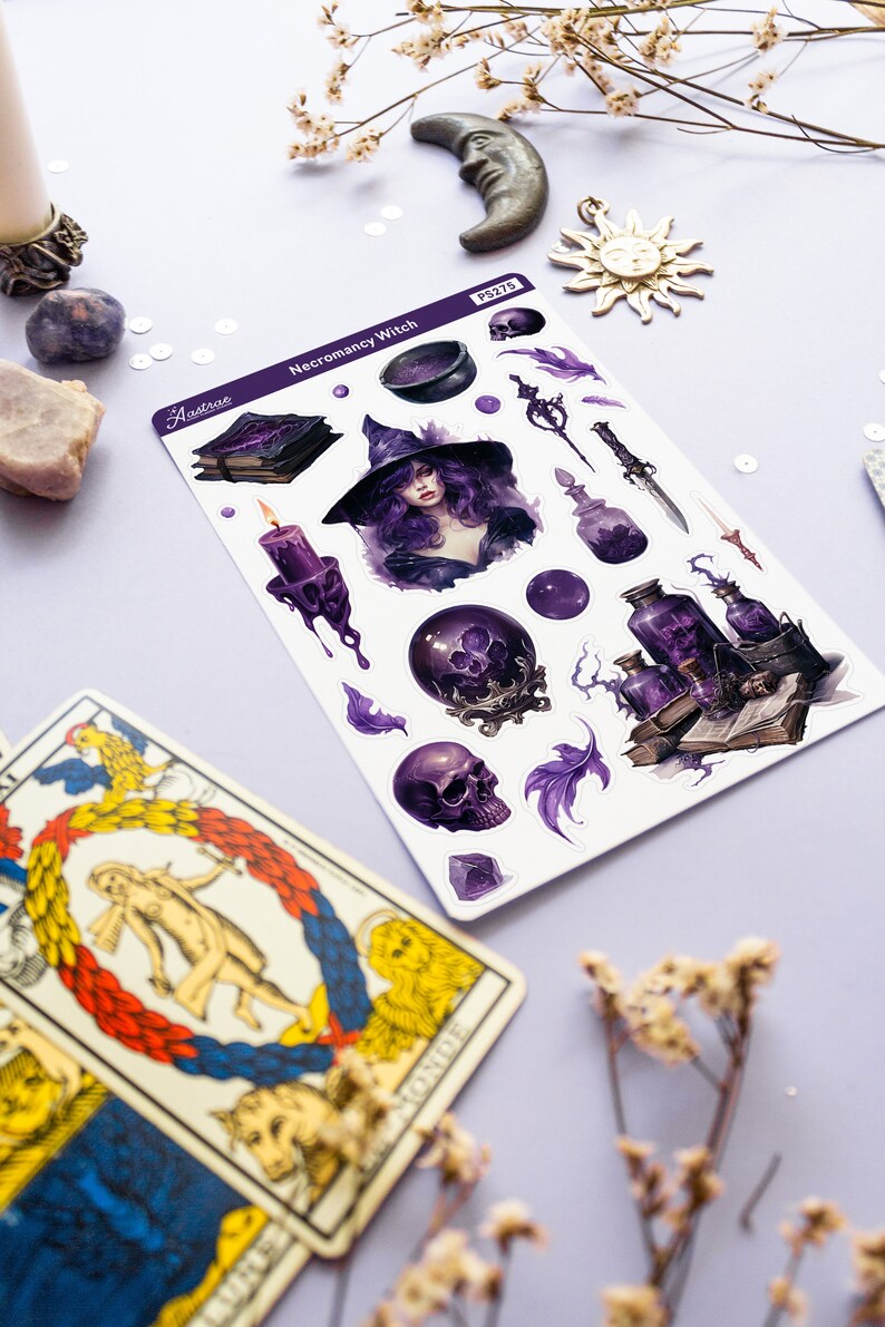 May include: A sheet of stickers featuring a purple and black witch with a cauldron, skulls, potions, and other magical items. The stickers are labelled "Necromancy Witch" and "Aastrae".