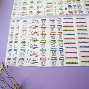 May include: A set of colorful planner stickers with various witchy themes, including daily cards, tarot reading, burn incense, cleanse crystals, charge crystals, intentions, and meditations.