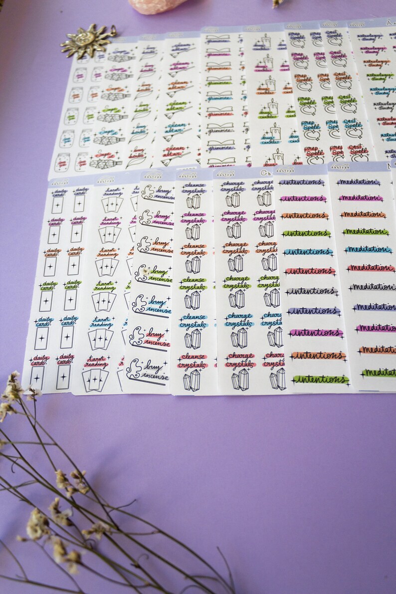 May include: A set of colorful planner stickers with various witchy themes, including daily cards, tarot reading, burn incense, cleanse crystals, charge crystals, intentions, and meditations.