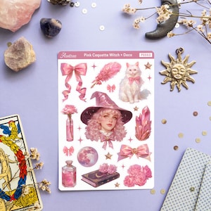 May include: A sheet of pink and white stickers featuring a pink-haired witch with a pink hat and a white cat. The stickers also include a pink bow, a feather, a crystal, a bottle of potion, a book, and a moon. The sheet is labeled "Pink Coquette Witch + Deco" and "PS553".