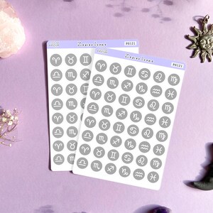 May include: Two sheets of stickers with gray circles featuring white zodiac symbols. The sheets are labeled "Zodiac Icons" and "PS121".