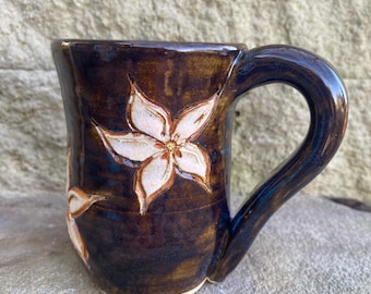 Pottery mug with flowers