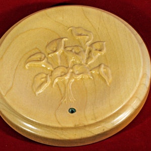 BS213 - A 4.9 to 5 Inch Diameter Unique display stand depicting a carved set of Lillies recessed in the middle.  The wood is Maple.