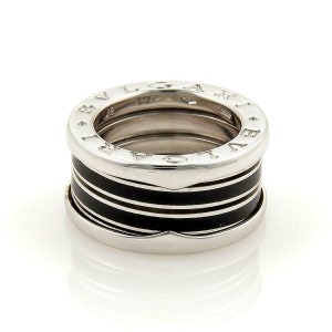 May include: A silver ring with black enamel bands and the inscription "BVLGARI" around the band.